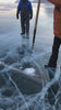 Video of person digging whole in ice with spear
